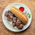 Dom's Original Steak Tips on a roll