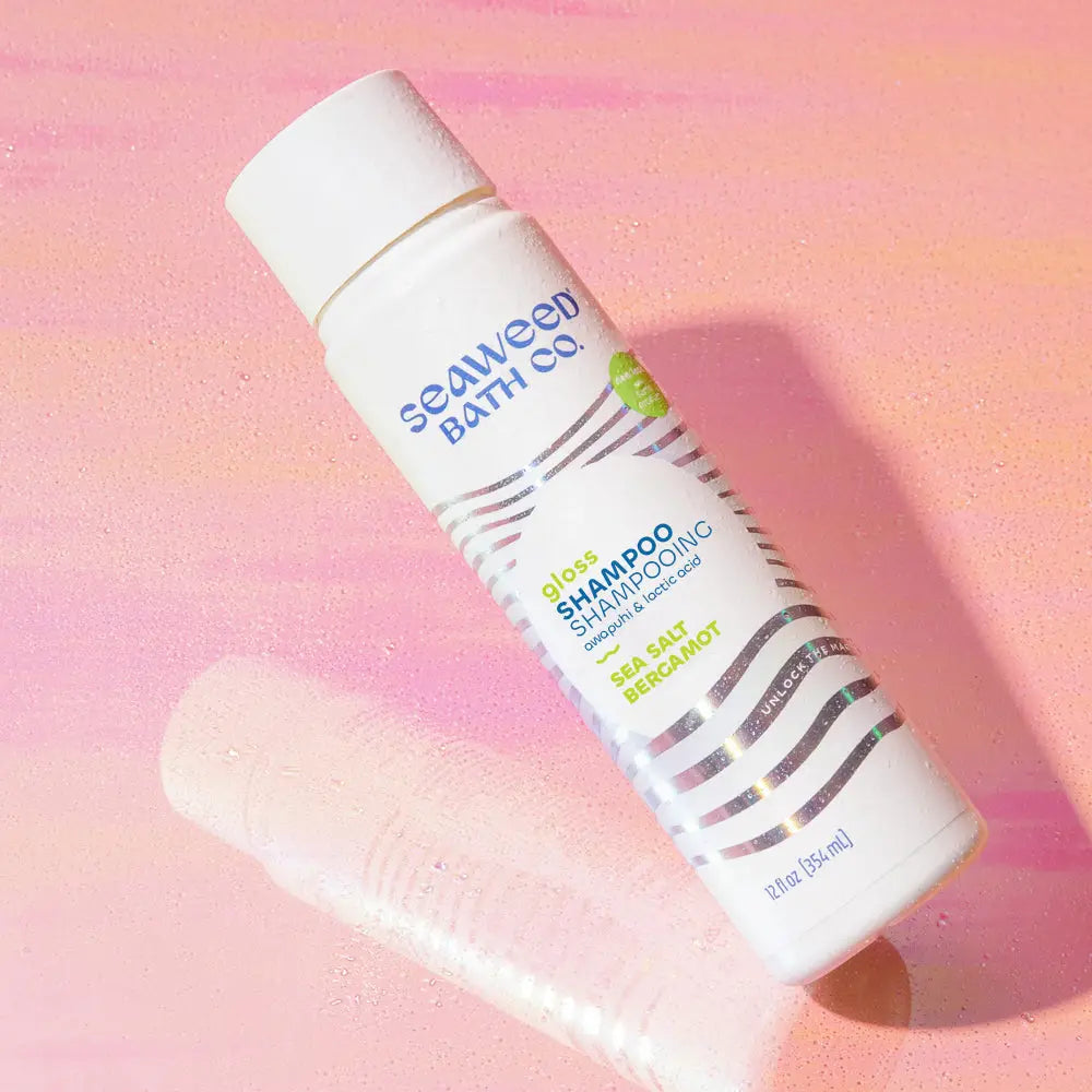 Seaweed bath co Gloss Shampoo on a pinkish background