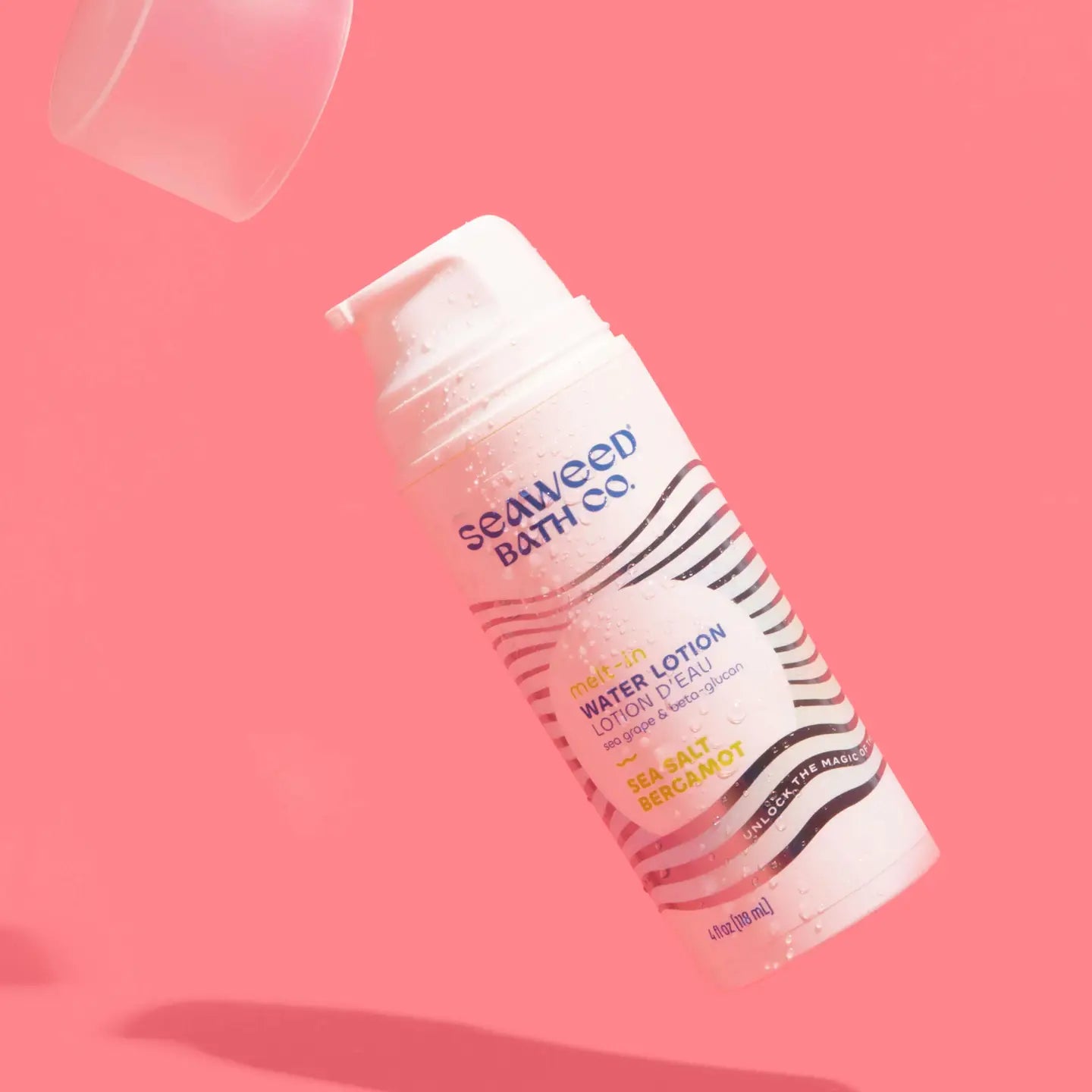 Seaweed Bath Co Melt-in Water lotion bottle on a pink background