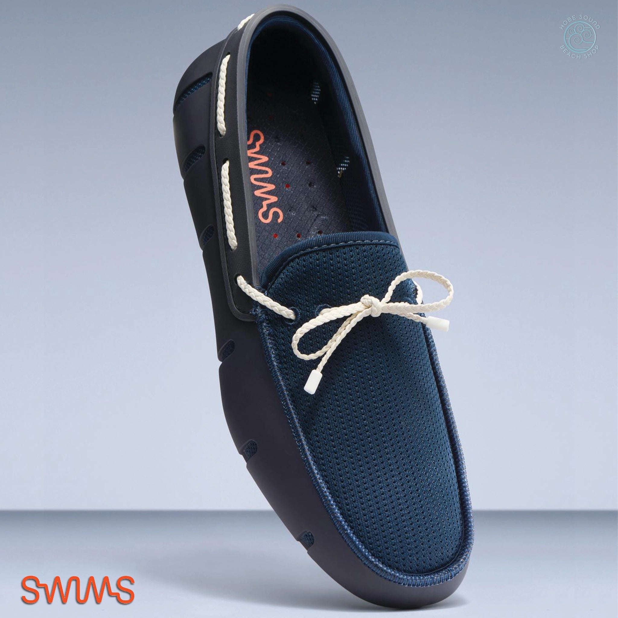 Blue loafer shoe with white laces on a gray background, featuring the brand 'Swims'.