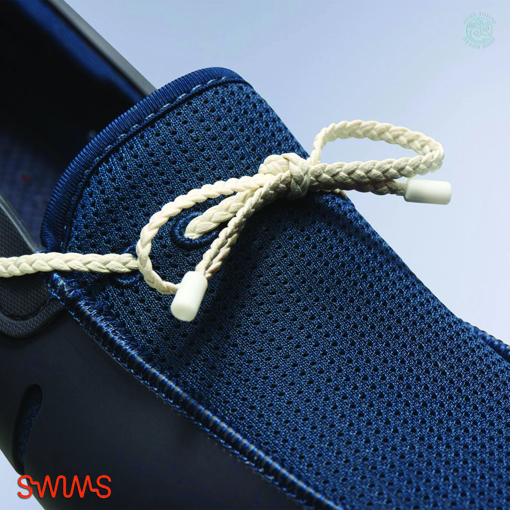 Blue and white Swims Braided Lace Loafers against a light blue background.