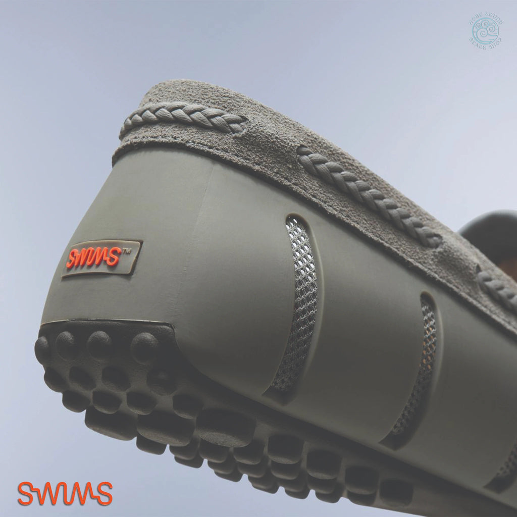 Close-up of a Swims Woven Driver in Grey on a light blue background
